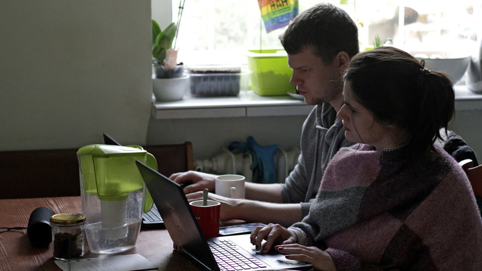 FILE PHOTO: Two people work from home during the outbreak of coronavirus disease (COVID-19), in Gdynia, Poland, March 16, 2020. REUTERS/Eloy Martin