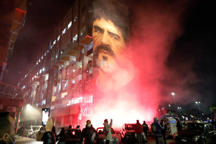 25 November 2020, Italy, Naples: Flares are lit as fans flock to Diego Maradona's mural in Naples. Argentina football great Diego Maradona has died at the age of 60, the Argentinian Football Association said on Wednesday. Photo: Fabio Sasso/LaPresse via ZUMA Press/dpa.
