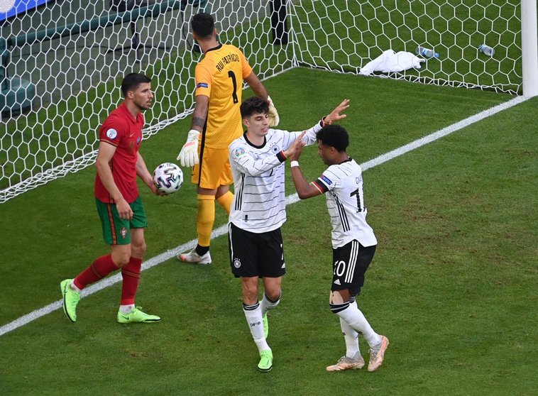 19 June 2021, Bavaria, Munich: Germany's Kai Havertz celebrates scoring his side's third goal with team mate Serge Gnabry during the UEFA EURO 2020 Group F soccer match between Portugal and Germany at the Allianz Arena. Photo: Federico Gambarini/dpa