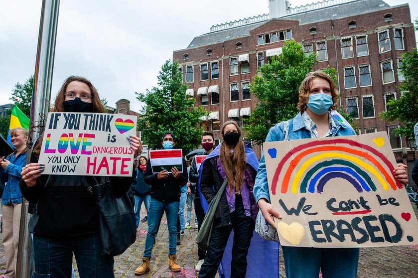 21 June 2021, Netherlands, Amsterdam: Two women hold placards during a demonstration against this legislation by Hungary's parliament bans the dissemination of content in schools deemed to ˜promote homosexuality and gender change. Photo: Ana Fernandez/SOPA Images via ZUMA Wire/dpa.