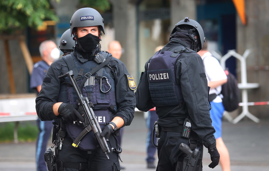 25 June 2021, Bavaria, Wuerzburg: Police officers stand in the city center near to the scene, where three people have been killed and five injured in a knife attack in downtown Wuerzburg on Friday. The alleged attacker was caught and detained, police said. Photo: Karl-Josef Hildenbrand/dpa.