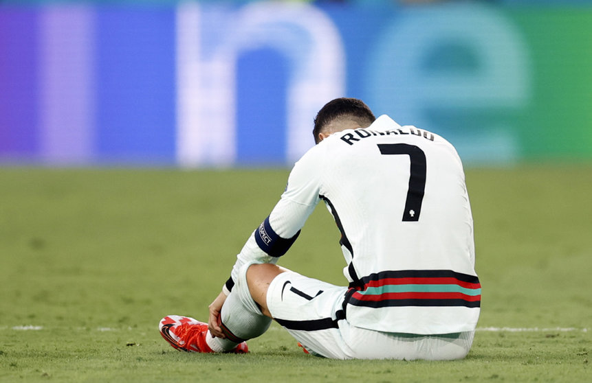 27 June 2021, Spain, Seville: Portugal's Cristiano Ronaldo lies on the turf after a collision during the UEFA EURO 2020 round of 16 soccer match between Belgium and Portugal at La Cartuja Stadium. Photo: Bruno Fahy/BELGA/dpa